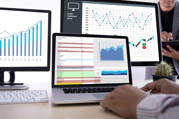 man on computer looking at data analytics